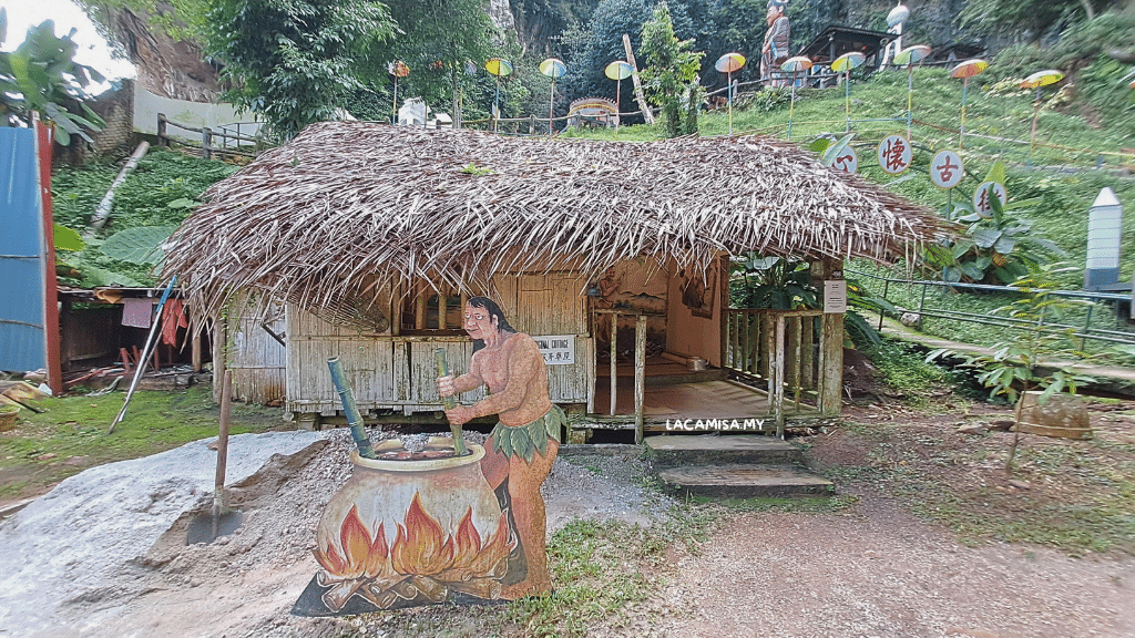 Another replica of indigenouse people's house with a 2D art in front of it.