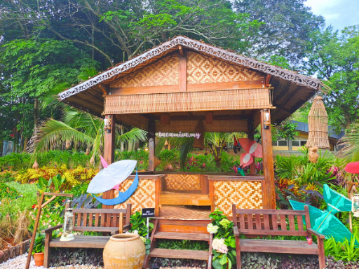 The garden also features traditional huts, enriching the scenic surroundings with a touch of cultural heritage.