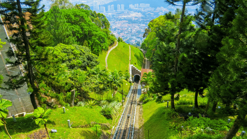 The funicular train at Penang Hill offers a thrilling ride up one of Malaysia’s steepest tracks, providing breathtaking views of lush greenery and the city below.