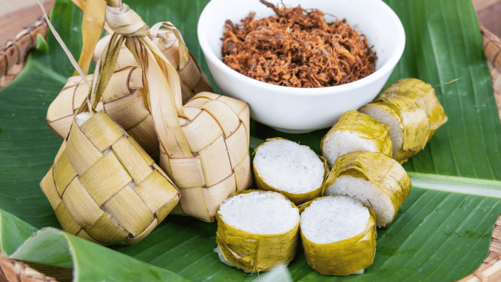 Malay culture and traditions during Hari Raya are beautifully reflected in the preparation and sharing of traditional dishes like ketupat and lemang, symbolizing togetherness and celebration.