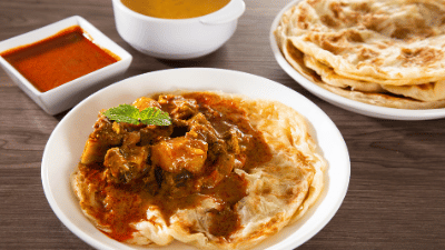 Roti Canai is a popular Malaysian flatbread, known for its flaky and crispy texture, typically served with dhal, curry, or sambal, making it a beloved breakfast or snack option.