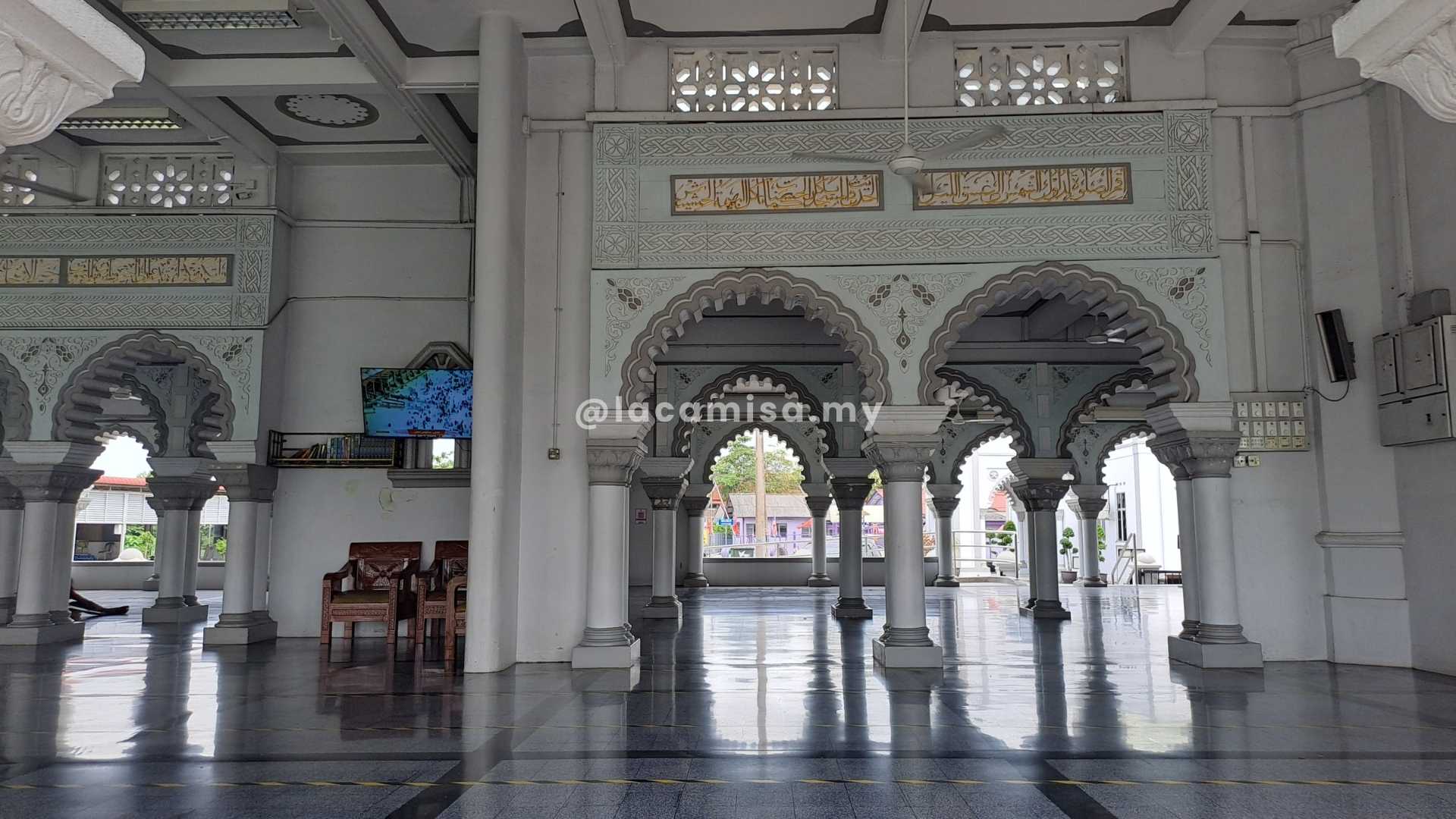 The elegant arches and detailed Islamic calligraphy crafted on the walls of Masjid Zahir, Kedah