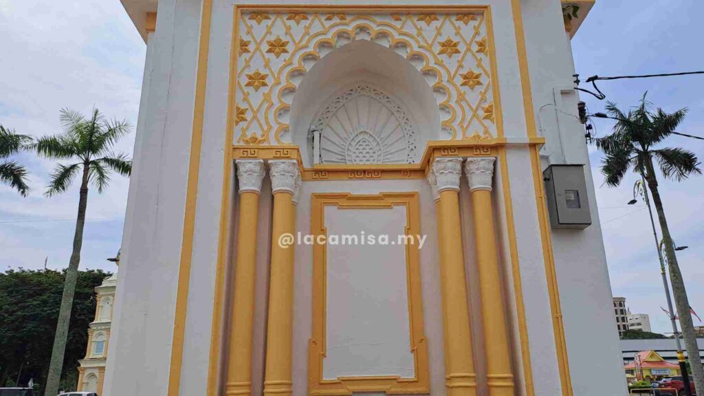 The Clock Tower in Alor Setar showcases early 20th-century architecture with colonial and local influences, a golden-white façade, and a crescent-topped dome symbolizing Islam.