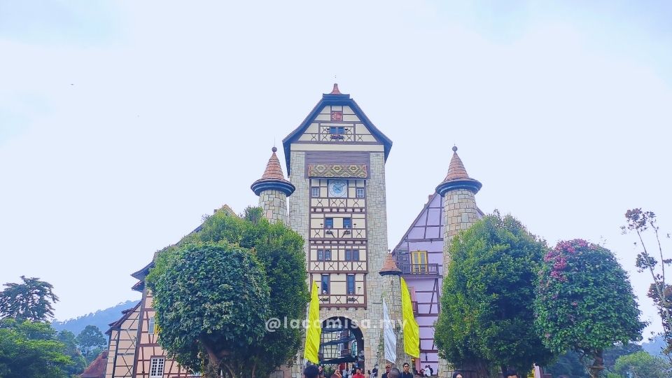 Colorful European-inspired building façades with pastel tones, arched windows, and wrought-iron balconies in French Village, Bukit Tinggi.
