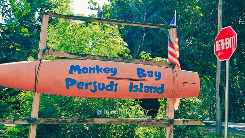 Monkey Bay, Perjudi Island written at the signage entrance to the private beach
